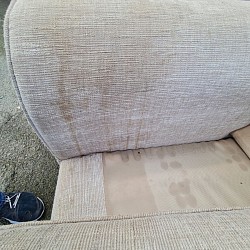 Tea stained arms of a sofa before pic